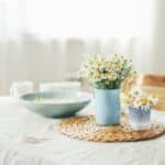 Before and after images of a stained linen tablecloth being cleaned