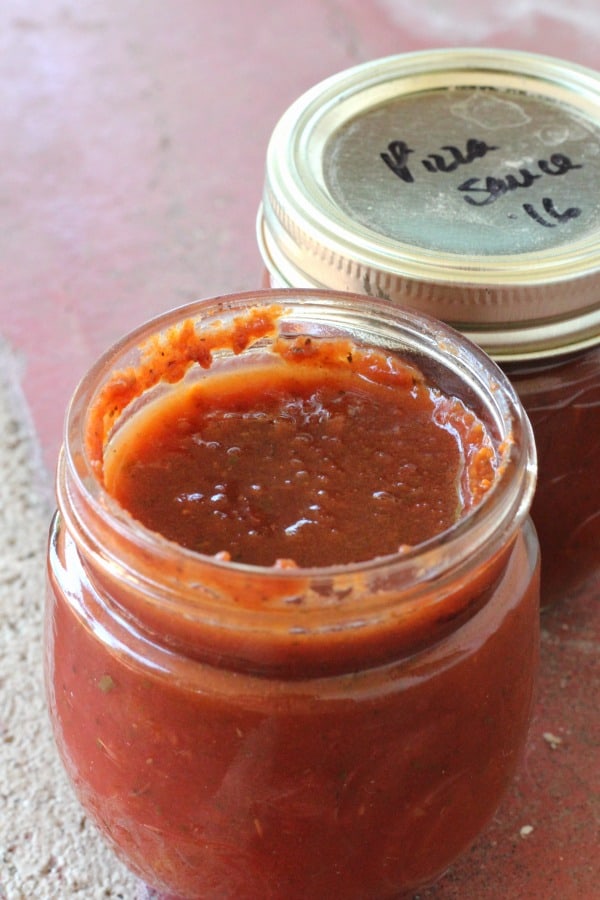 Open jar of homemade canned pizza sauce