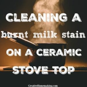 cleaning a burnt milk stain from a black ceramic stove top