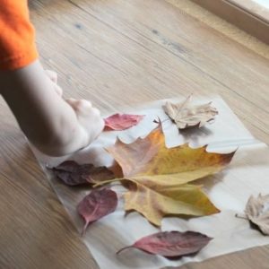 Placemats made from fall leaves are a fun Thanksgiving craft activity for kids of all ages.