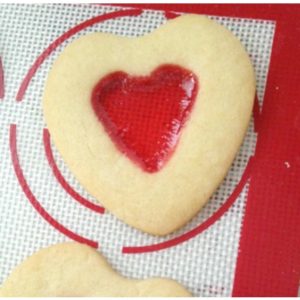 Easy recipe for homemade stained glass heart cookies to make for Valentine's Day. A great DIY treat for kids for Valentine's Day.