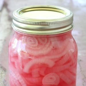Easy recipe for canning pickled red onions to enjoy in salads an on sandwiches all year round.
