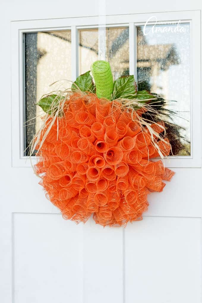 Easy deco mesh pumpkin wreath to make for your front door for fall.