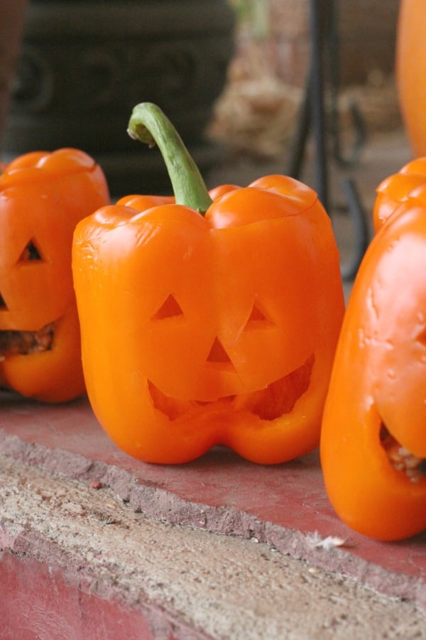 Easy Halloween dinner idea! Make these Halloween stuffed peppers mexican style, with spaghetti, or vegetarian.