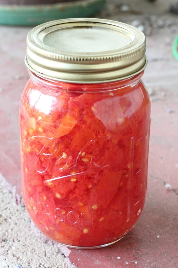 Easy recipe for canning chopped tomatoes in a water bath. One of my favorite recipes for canning tomatoes!