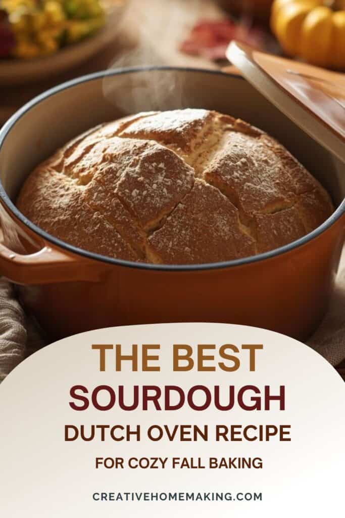 Sourdough bread loaf dusted with flour beside autumn leaves and a Dutch oven