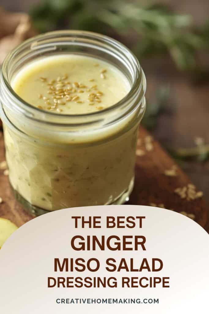 A bottle of homemade miso ginger dressing next to fresh ingredients like garlic, ginger, and a bottle of rice vinegar.