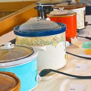 Crock pot being cleaned with a soft cloth and warm water