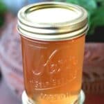 Homemade lavender jelly in a jar with fresh lavender sprigs