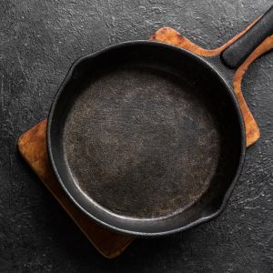 Cast iron skillet being seasoned with oil