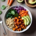 Colorful Buddha bowl with sweet potatoes, spinach, carrots, chickpeas