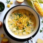 Bowl of creamy corn and potato chowder garnished with fresh herbs