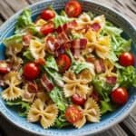 Bowl of easy BLT pasta salad with bacon, lettuce, tomatoes, and creamy dressing