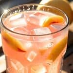 Pitcher of peach lemonade with fresh peach slices and mint garnish