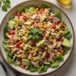 Bowl of Southwestern chicken salad with grilled chicken, black beans, corn, avocado, and cilantro