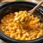 Bowl of creamy slow cooker macaroni and cheese topped with melted cheddar