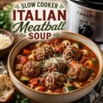 Warm up with a big bowl of Italian meatball soup made in the slow cooker. This hearty recipe combines savory meatballs, zucchini, carrots, tomatoes, pasta, and Parmesan for a delicious homemade meal. A perfect addition to your collection of cozy soup recipes and comforting fall recipes.