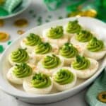 White eggs with green deviled filling, styled for St. Patrick’s Day food